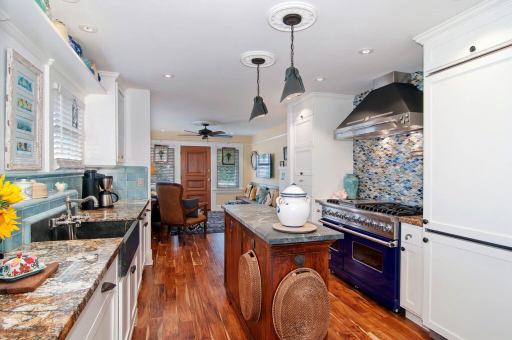 A kitchen with wood floors and blue appliances.