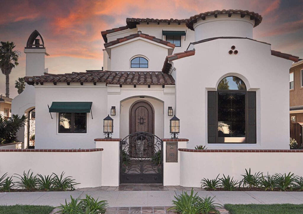 White Mediterranean home with iron gate.
